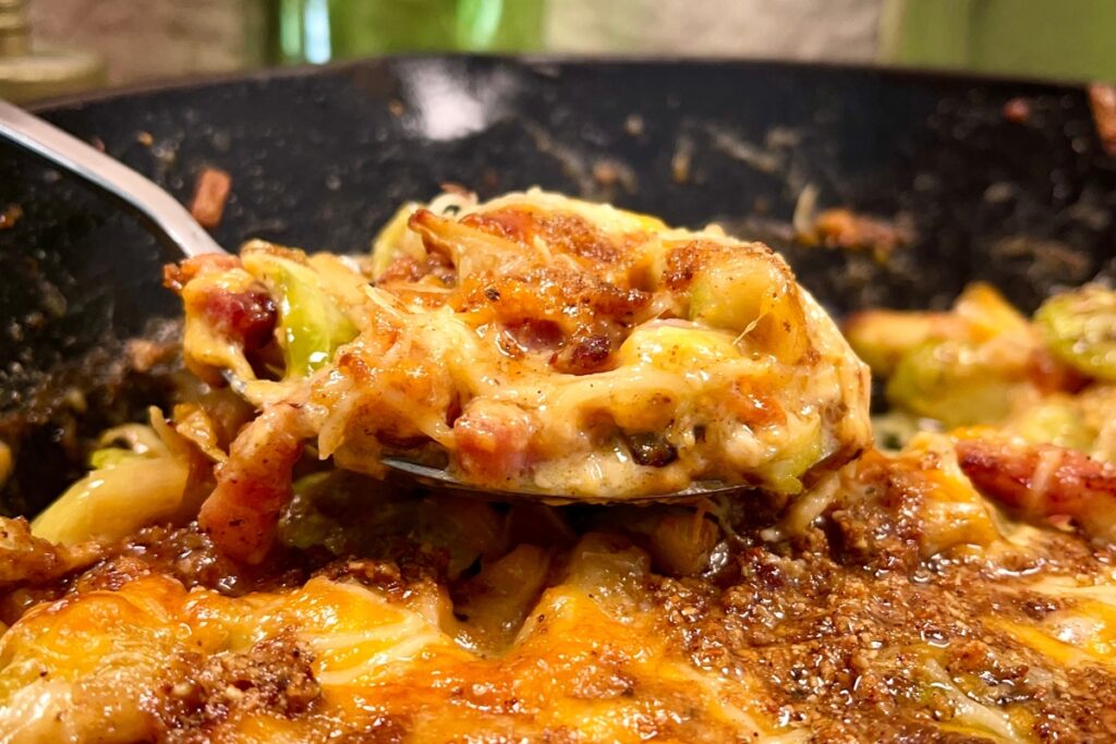 Close up of cheesy Brussels sprout casserole in a pan