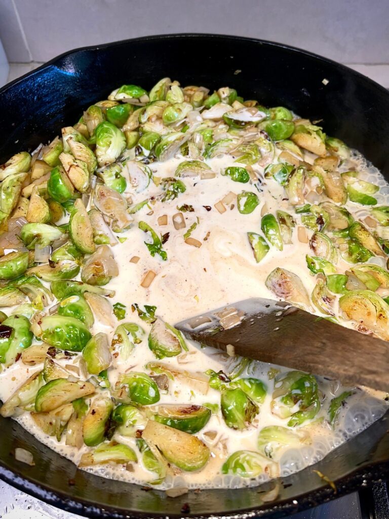 Cheesy Brussel sprouts ingredients being cooked in a pan