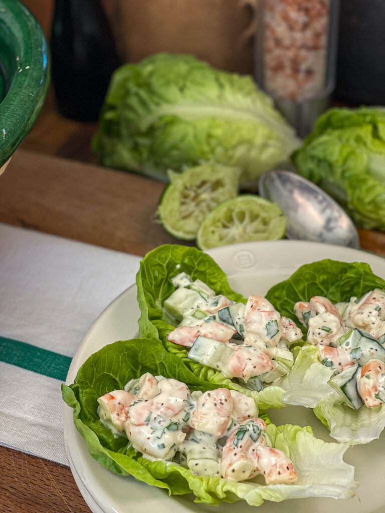 Plate of keto shrimp salad served in leaves of lettuce