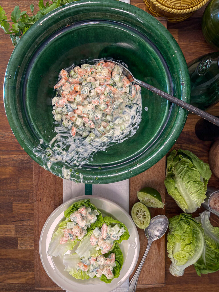 Keto shrimp salad in a bowl being prepared in lettuce