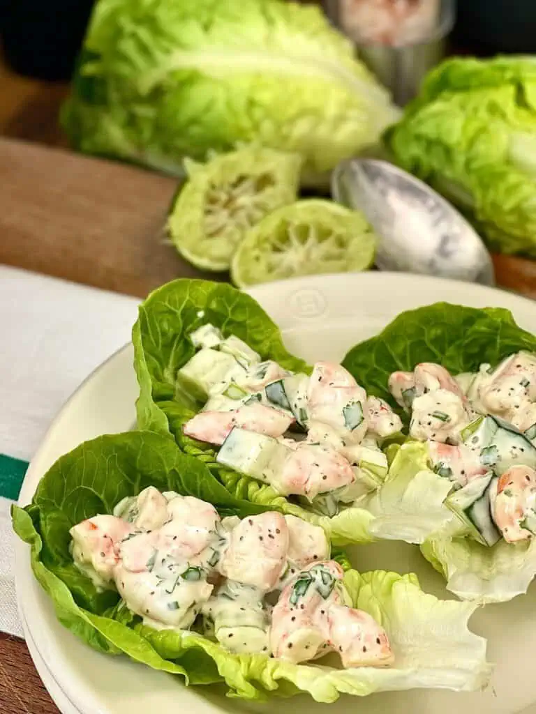 three shrimp salad lettuce wraps on a plate
