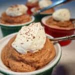 Five bowls of keto chocolate mousse topped with low carb whipped cream