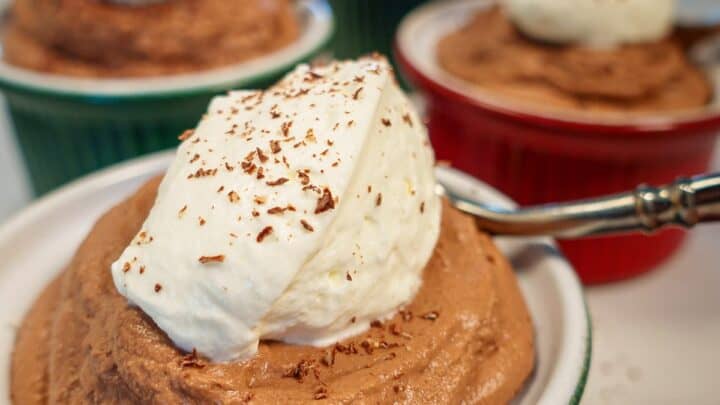 Five bowls of keto chocolate mousse topped with low carb whipped cream