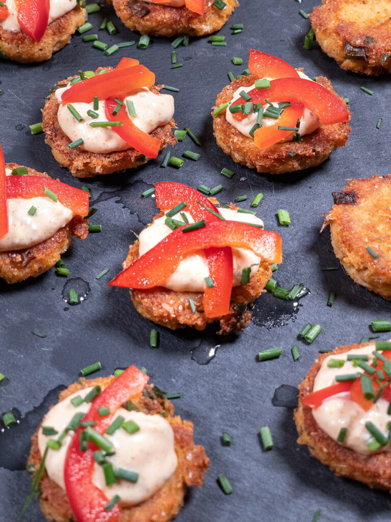 Keto-crab-cakes-on-a-platter-topped-with-fresh-herbs