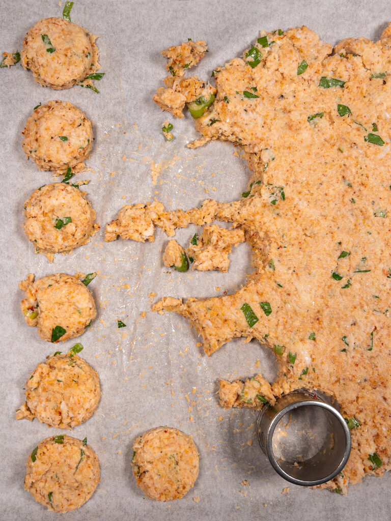 Ingredients for keto crab cakes Being shaped on a baking sheet