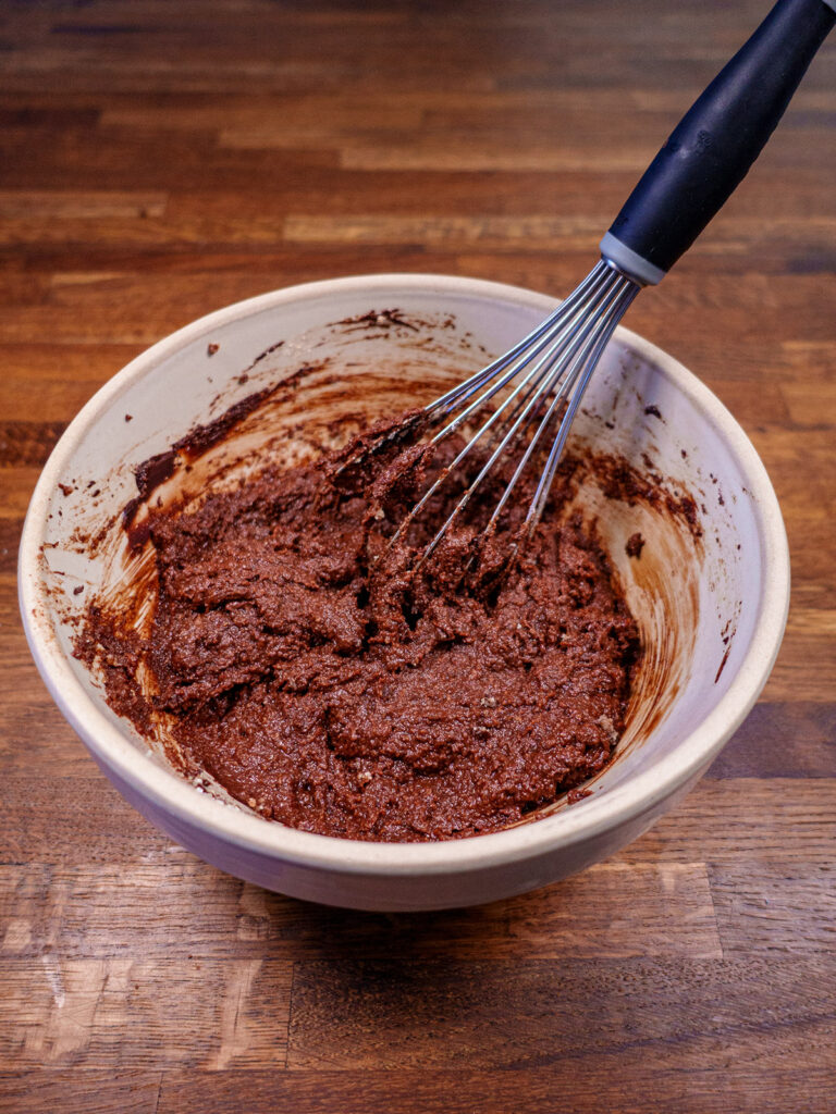 Bowl of ketogenic brownie batter with a whisk