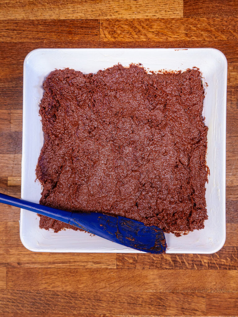 Ingredients if ketogenic brownies being spread into baking dish