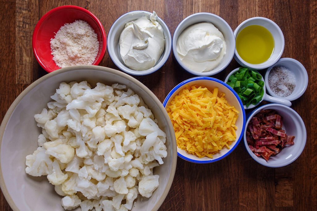 Bowls of ingredients for loaded cauliflower bake