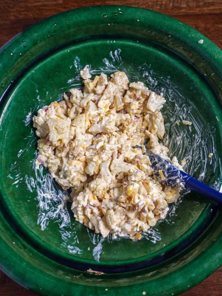 Bowl of mixed ingredients for loaded cauliflower bake