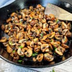 sauteed-mushrooms-in-a-pan-topped-with-fresh-herbs