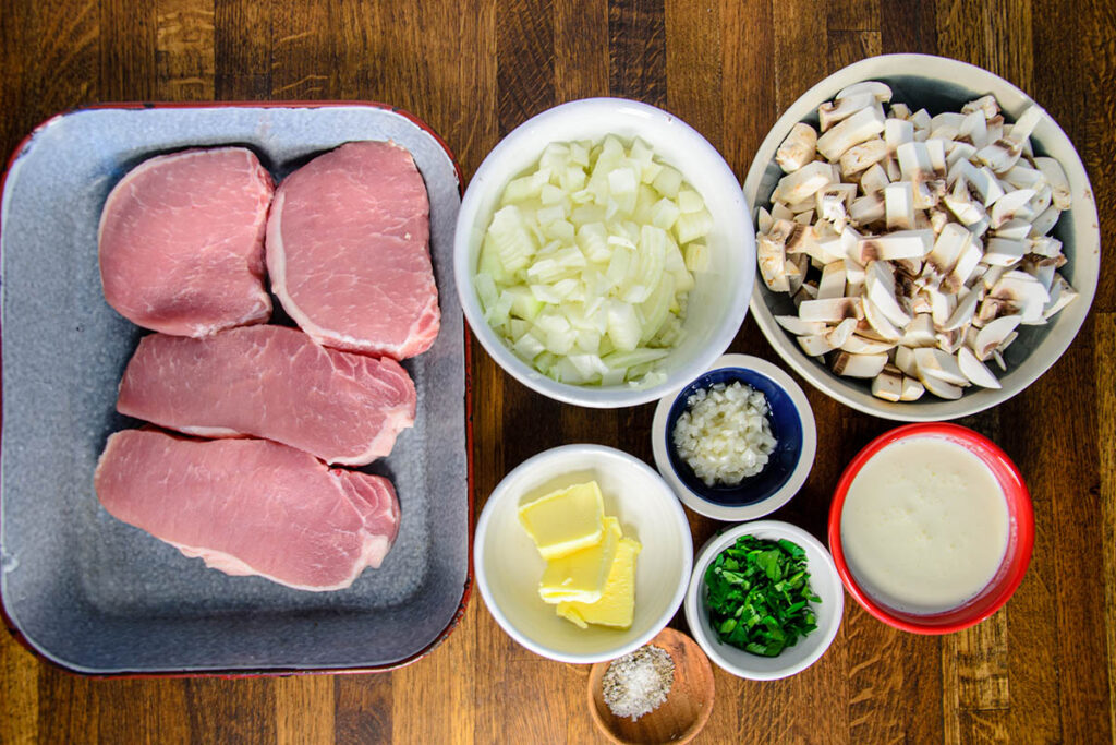 Bowls and platters of smothered pork chops ingredients