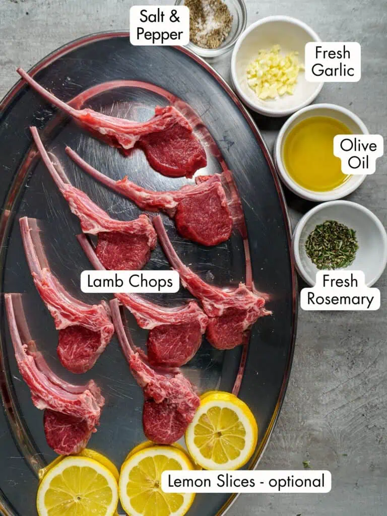 Lamb chop recipe ingredients including lemon, lamb chops, rosemary, salt, pepper, fresh garlic and olive oil placed on a silver platter with text descriptions