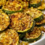 Close up of baked zucchini rounds with parmesan cheese, a Low Carb, Keto, Gluten Free and Vegetarian recipe