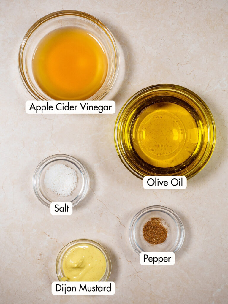 Ingredients to make apple cider vinaigrette salad dressing