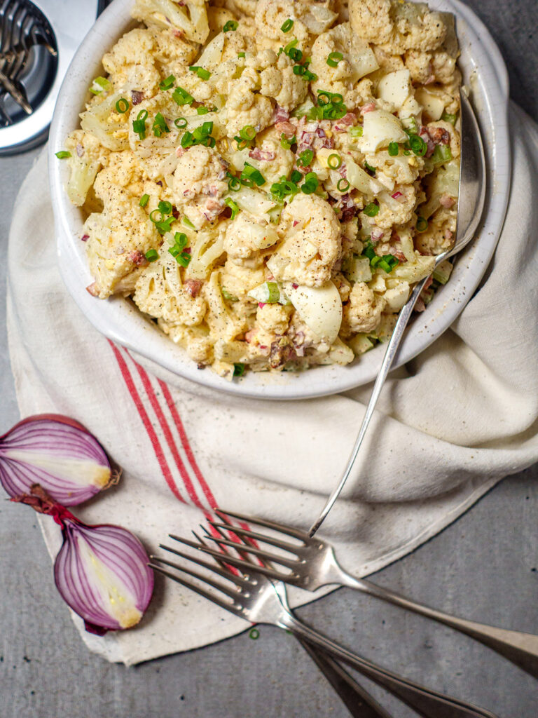cauliflower-potato-salad-in-a-bowl-sprinkled-with-garnishment