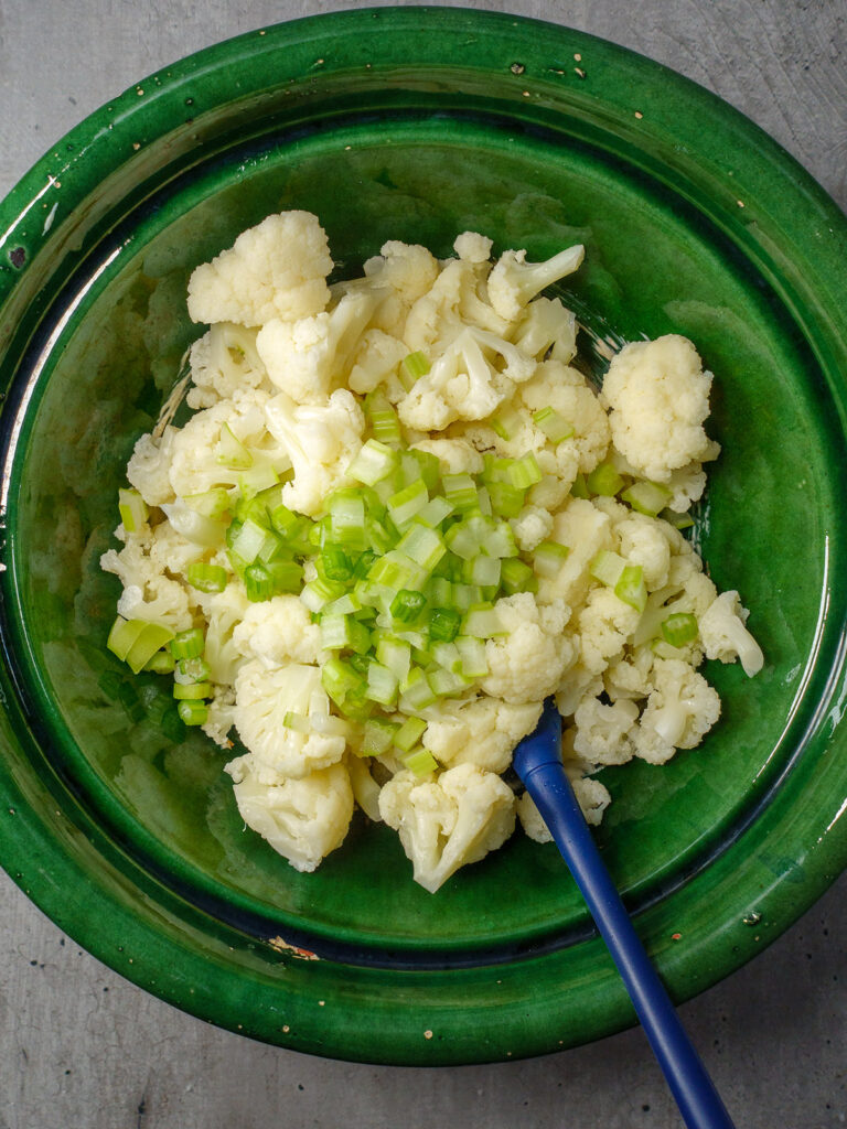cauliflower-florets-and-chopped-celery-in-a-bowl