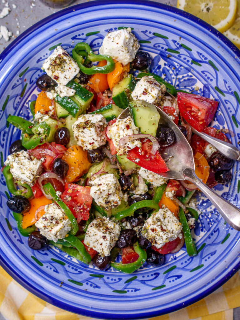 close -up- look-of-the-Greek-salad-in-the-spoon-above-the-plate