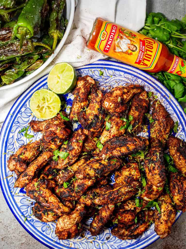 close-up-look-of-chili-lie=me-wings-on-a-plate-seasoned-with-parsley-and-lime-on-the-side