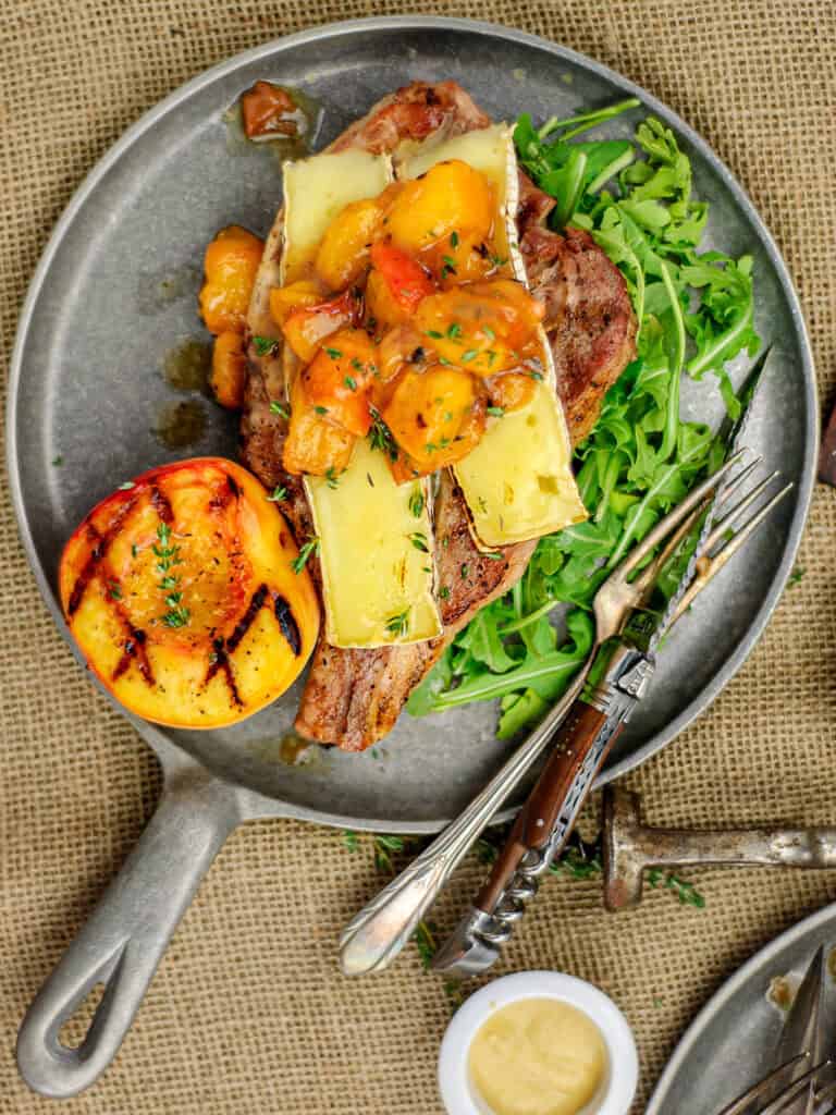 Overhead-look-at-served-grilled-pork-chops-with-seasonings-and-garnishes