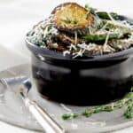 Sauteed-zucchini-in-a-black-dish-topped-with-fresh-herbs-featured-image