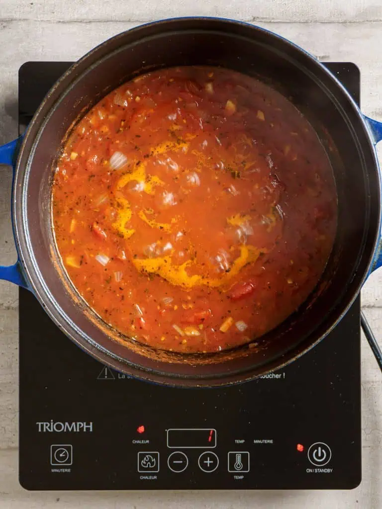 Tomato bisque mixture simmering in the pot.