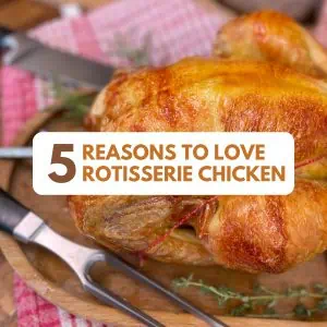 Close-up of a carving fork and knife cutting into a juicy rotisserie chicken on a wood board.