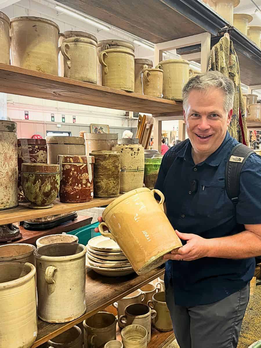 Scott Groth choosing antiques at a market in Provence